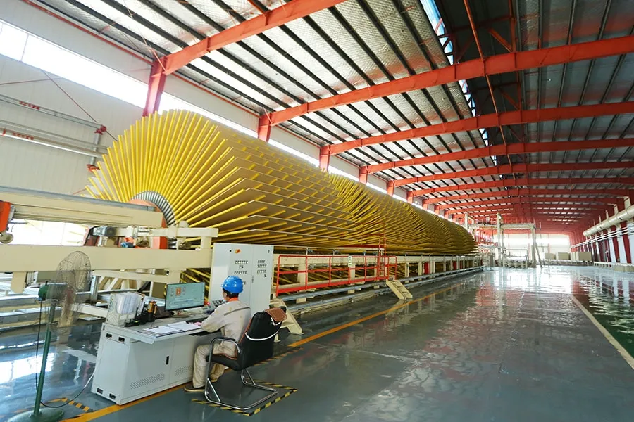 Star cooler wheel with an operator seated at a monitoring station on a Ningfeng production line